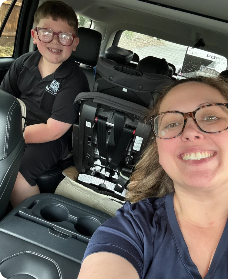 Allison taking a selfie in the car with her smiling son