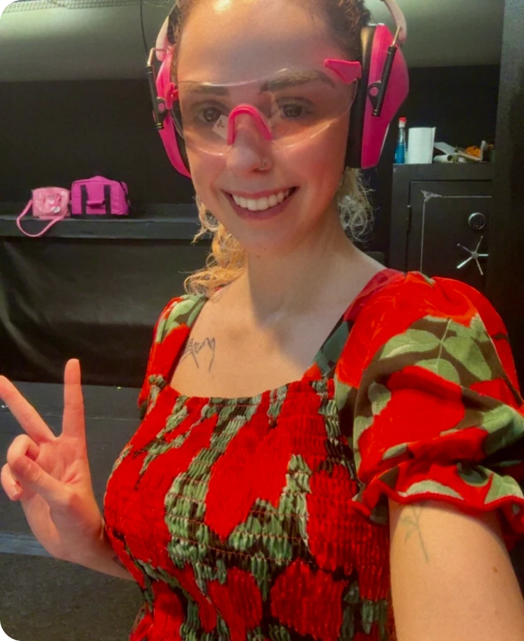 Laura wearing safety glasses and ear protection at the shooting range