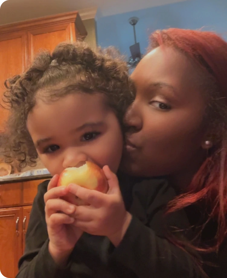 Jenn hugging her toddler in the kitchen
