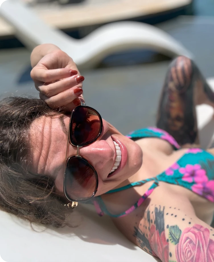 Jessica lounging by the pool in the sun