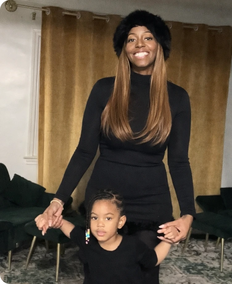 Becky holding hands with her child at home